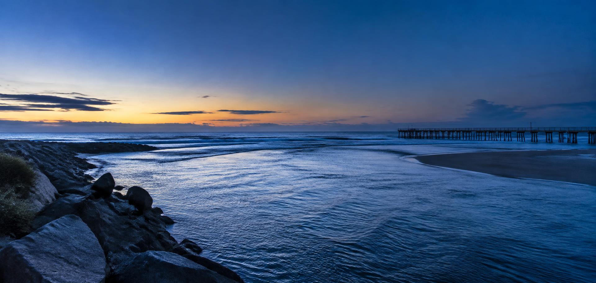 River mouth meeting the ocean at dawn